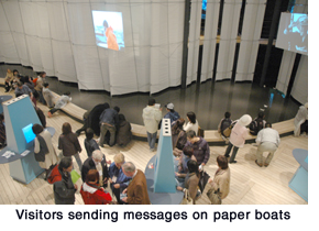 Visitors sending messages on paper boats