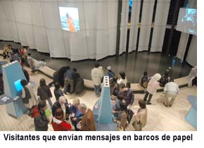 Visitors sending messages on paper boats