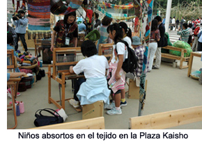 Children engrossed in weaving at the Kaisho Plaza