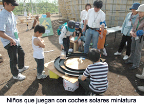 Children playing with miniature solar cars