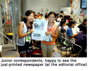 Junior correspondents, happy to see the just-printed newspaper (at the editorial office)