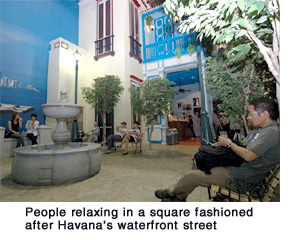 People relaxing in a square fashioned after Havana's waterfront street