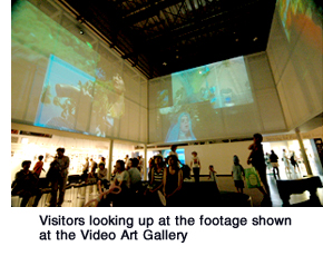 Visitors looking up at the footage shown at the Video Art Gallery